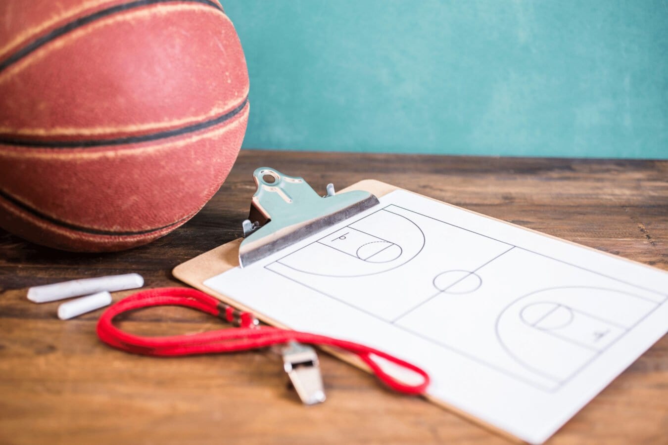 Basketball, whistle, chalk and clipboard